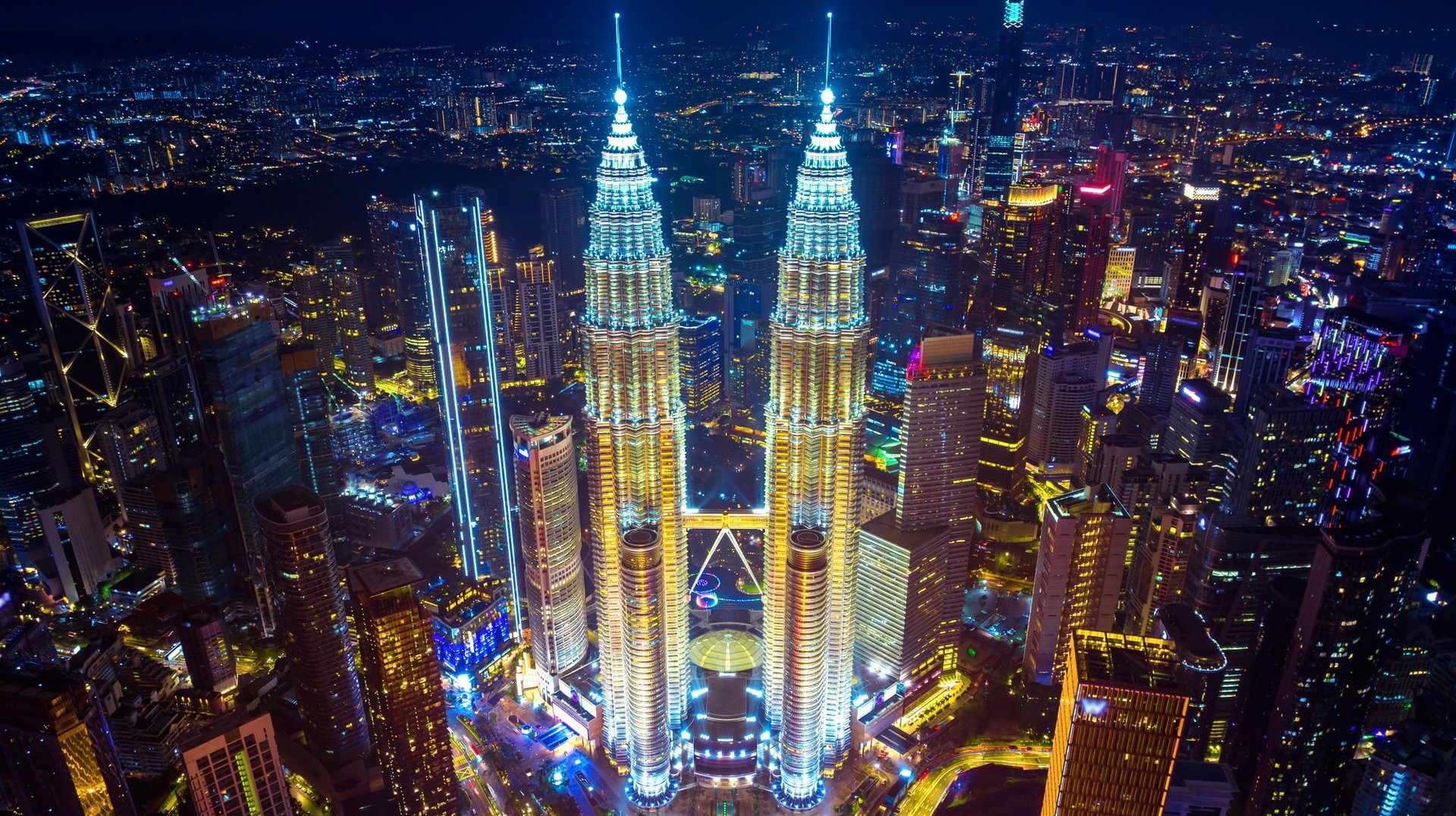 See Petronas Towers at night while spending one week in Malaysia.