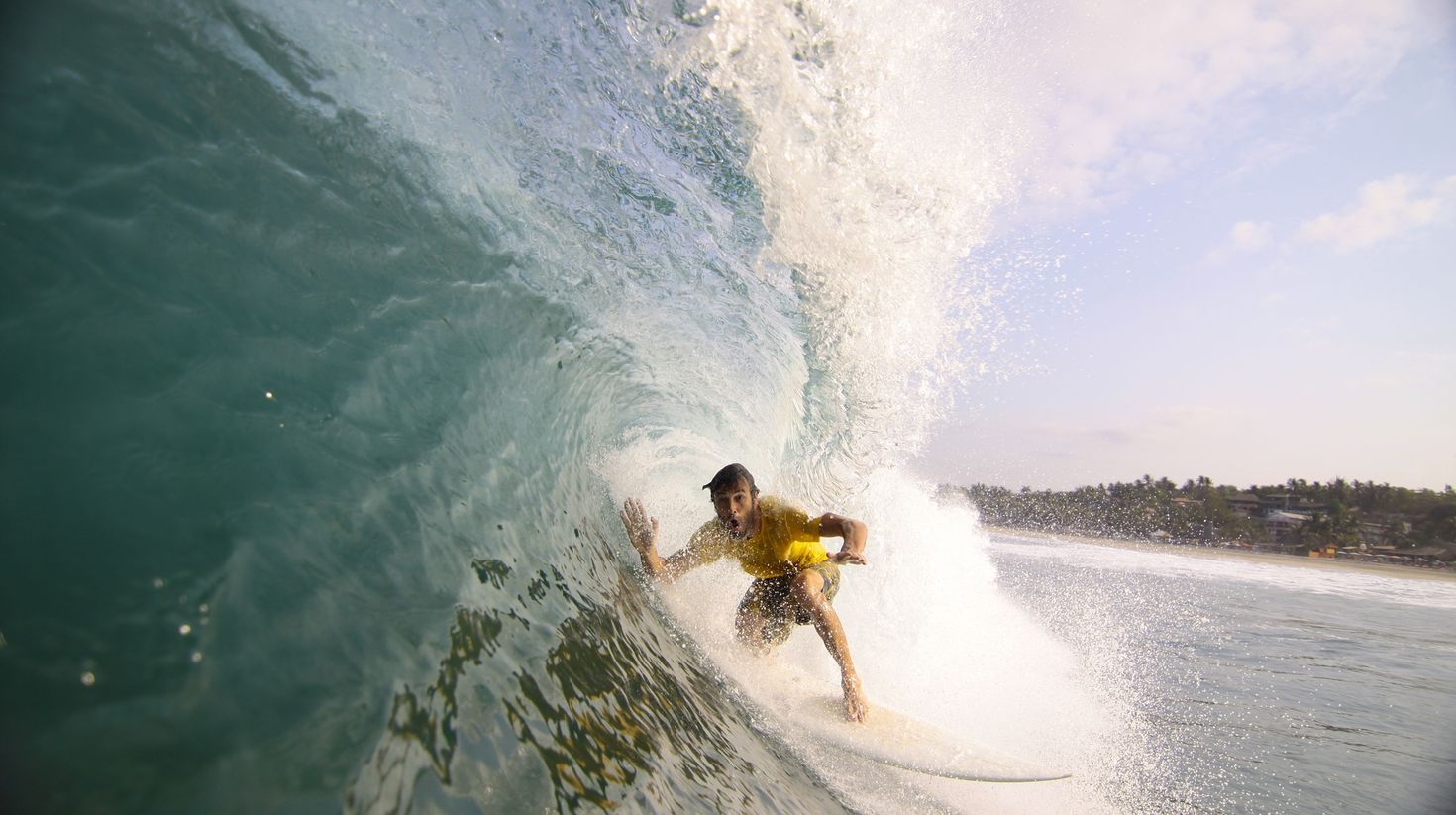 Surfer making his way into a blue water barrel in Mexico