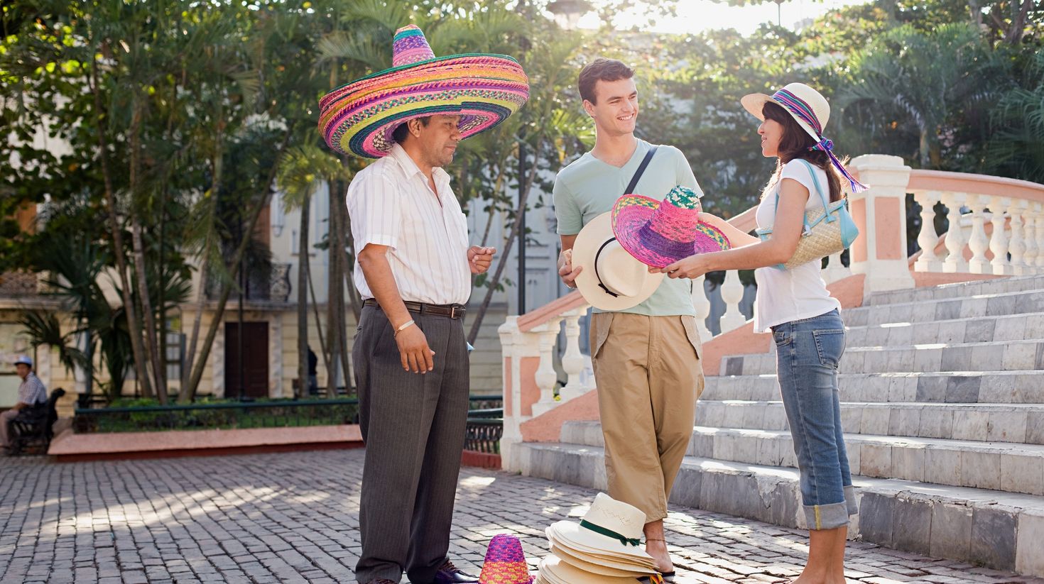 Couple and man selling hats stock photo