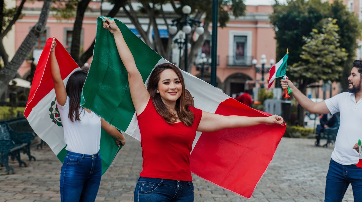 Proud mexican woman holding a flag of Mexico