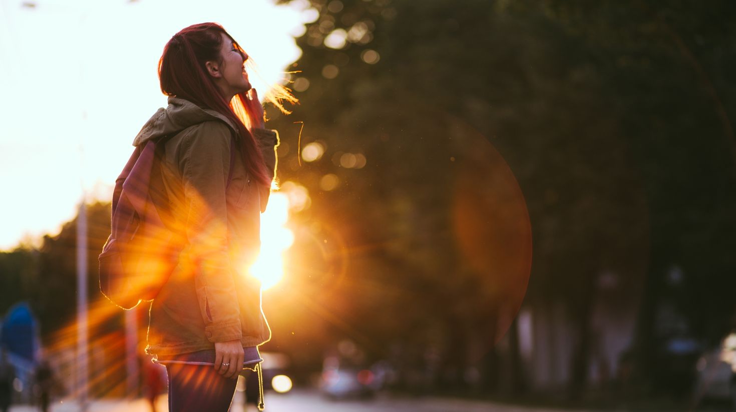 Smiling Young Red haired woman dressed in jacket