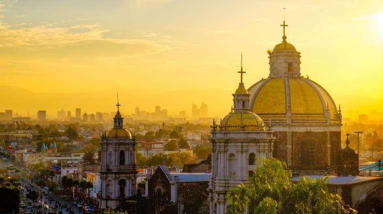 Scenic view at Basilica of Guadalupe with Mexico city skyline at sunset in Mexico in January.