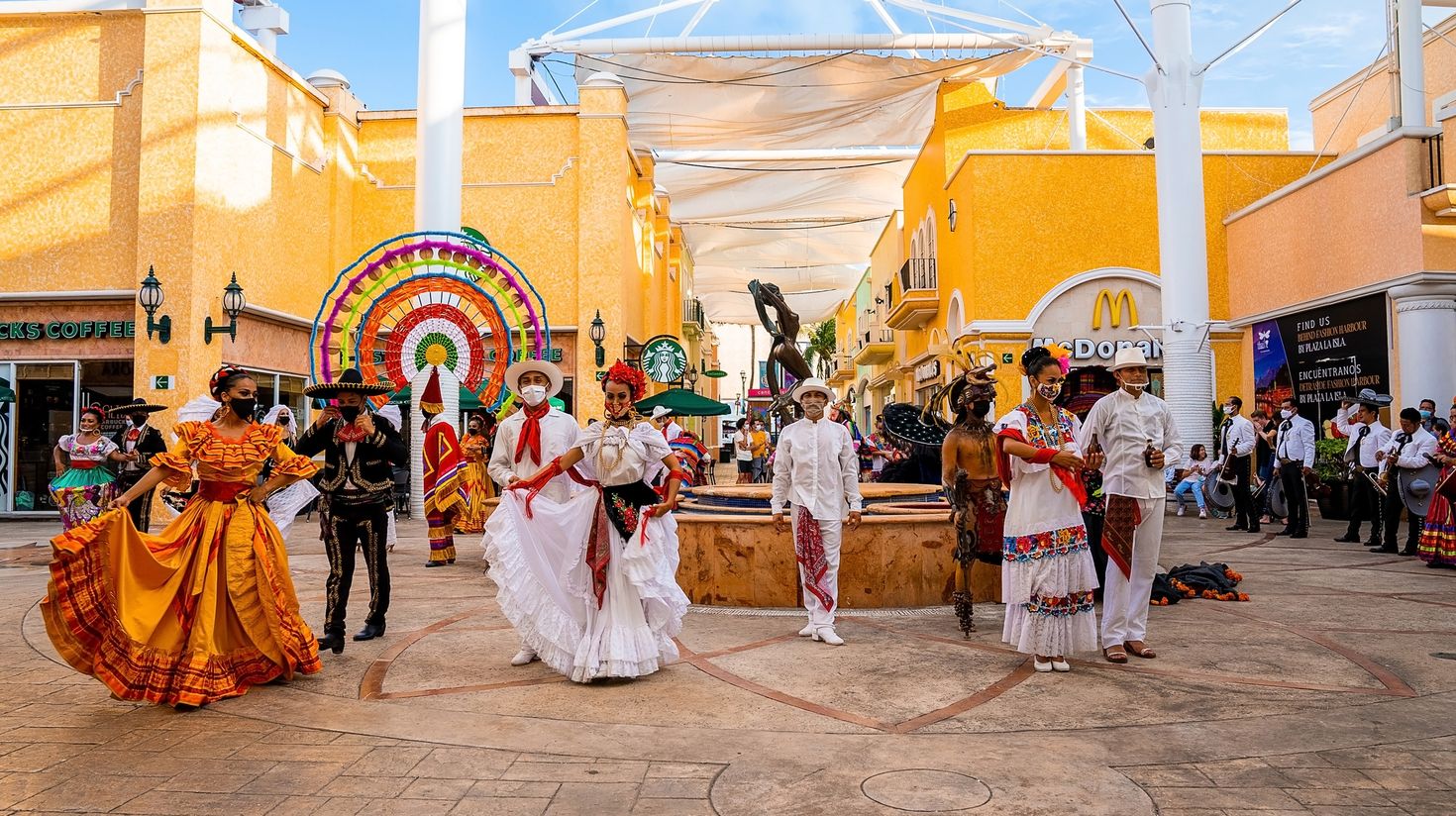 Mexican artists in traditional outfit performing during folklore festival