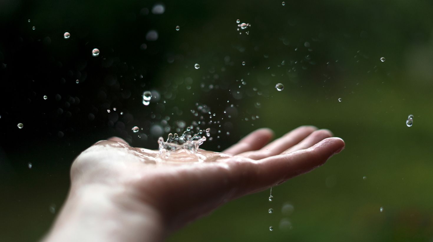 Hand catching raindrops