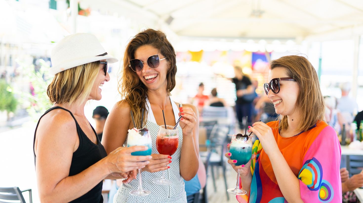 Women drinking cocktails on the party summer holiday