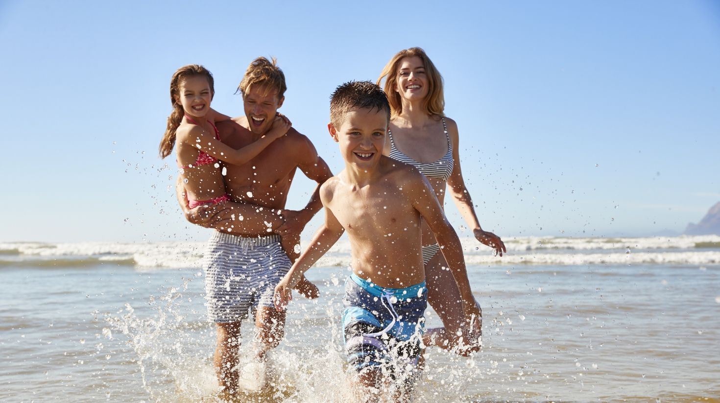 Family On Summer Beach Vacation