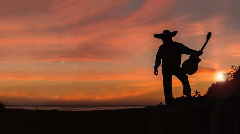 Silhouette of a Mexican musician with a guitar in Mexico in March.