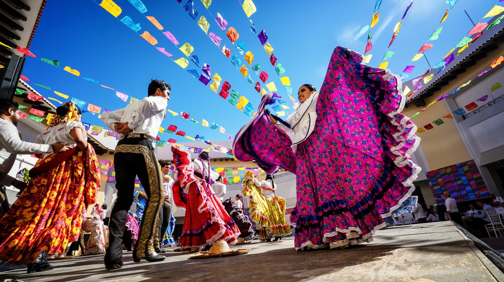 While the weather might be slightly unpredictable, a trip to Mexico in October is sure to pack lots of places to visit, things to do, and people to meet. Folklore dancers dancing in Mexico in October.