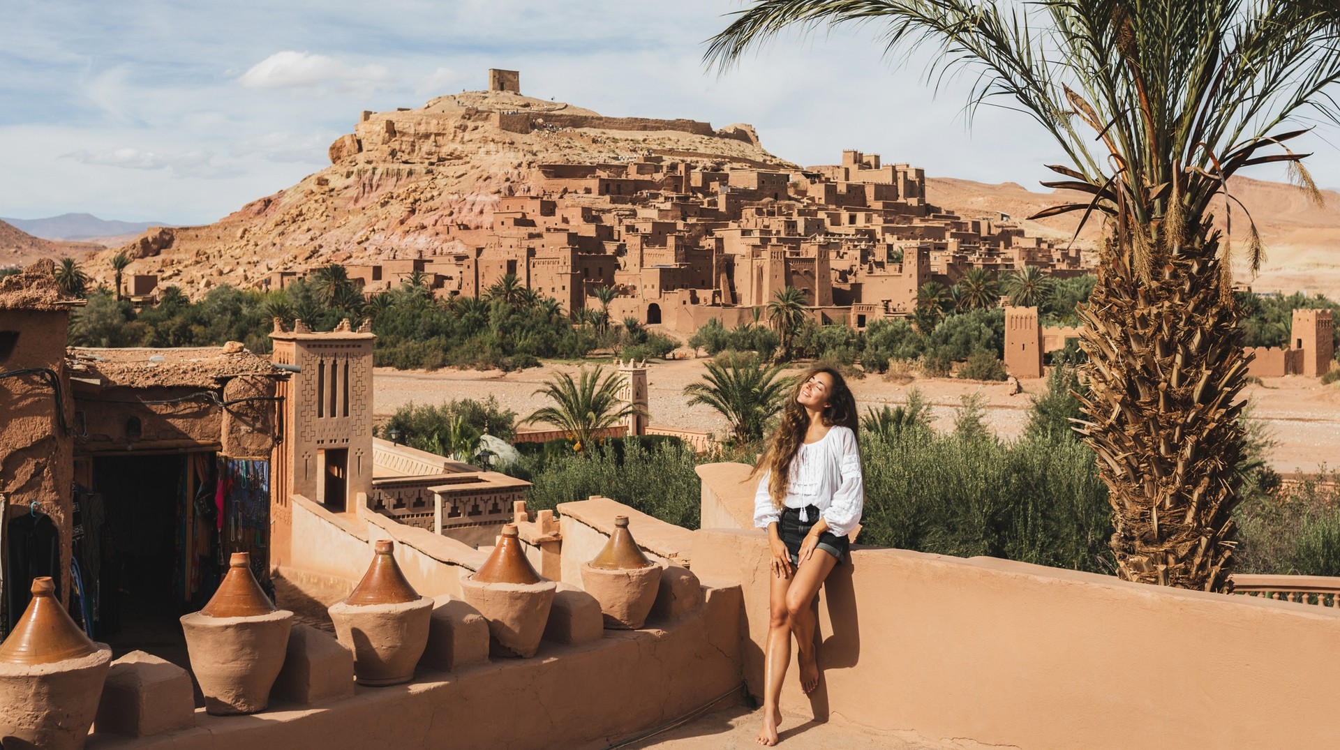 Aït Benhaddou is the former caravan route between the Sahara and Marrakesh in Morocco and is listed as a UNESCO World Heritage Site for its exemplary clay architectu Ait-Ben-Haddou-kasbah-on-background