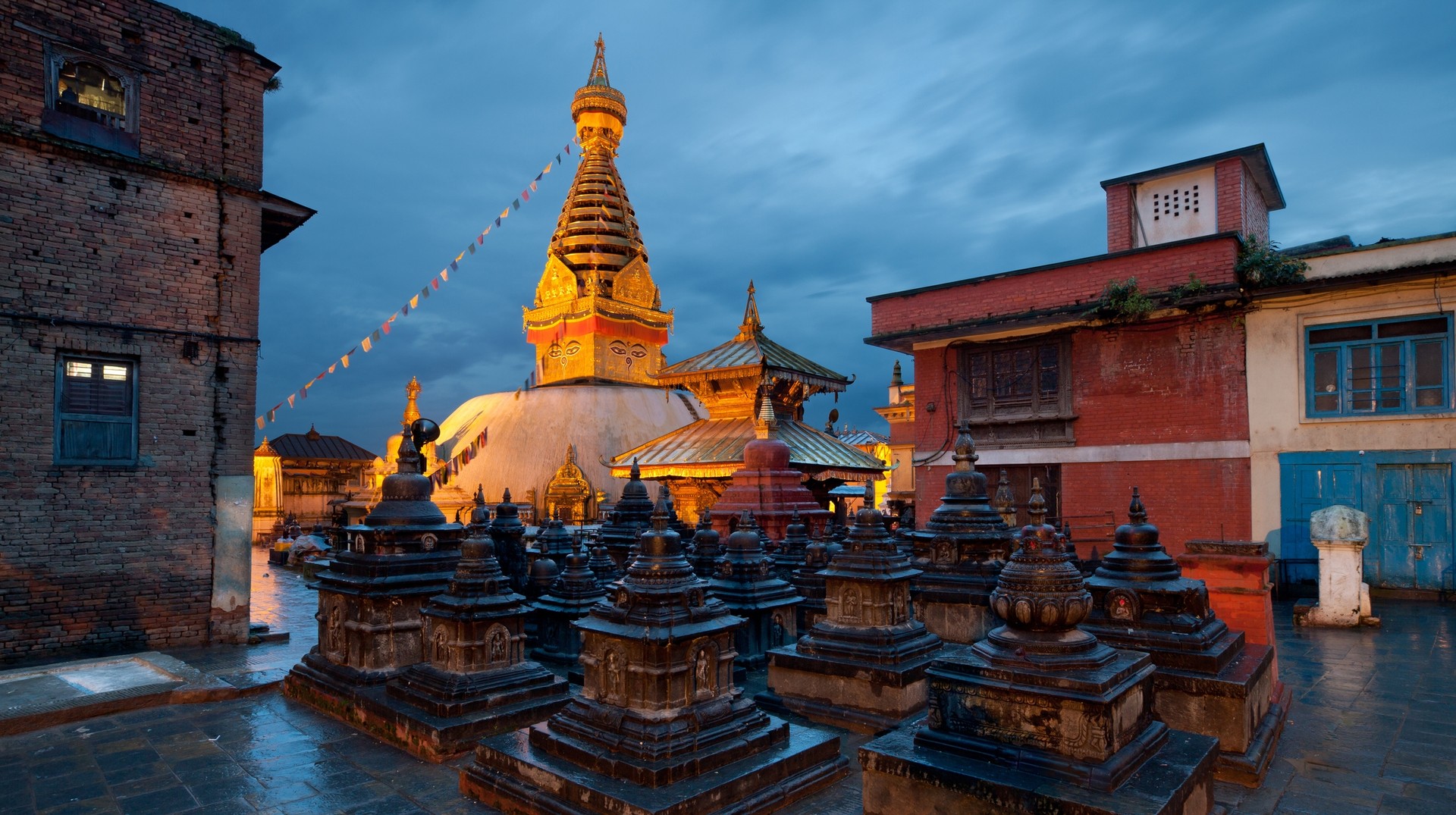 Experience the cultural depth of the Kathmandu Valley that has been washed clean by the monsoon rains Illuminated Swayambhunath temple against blue sky after rain in Nepal in July.