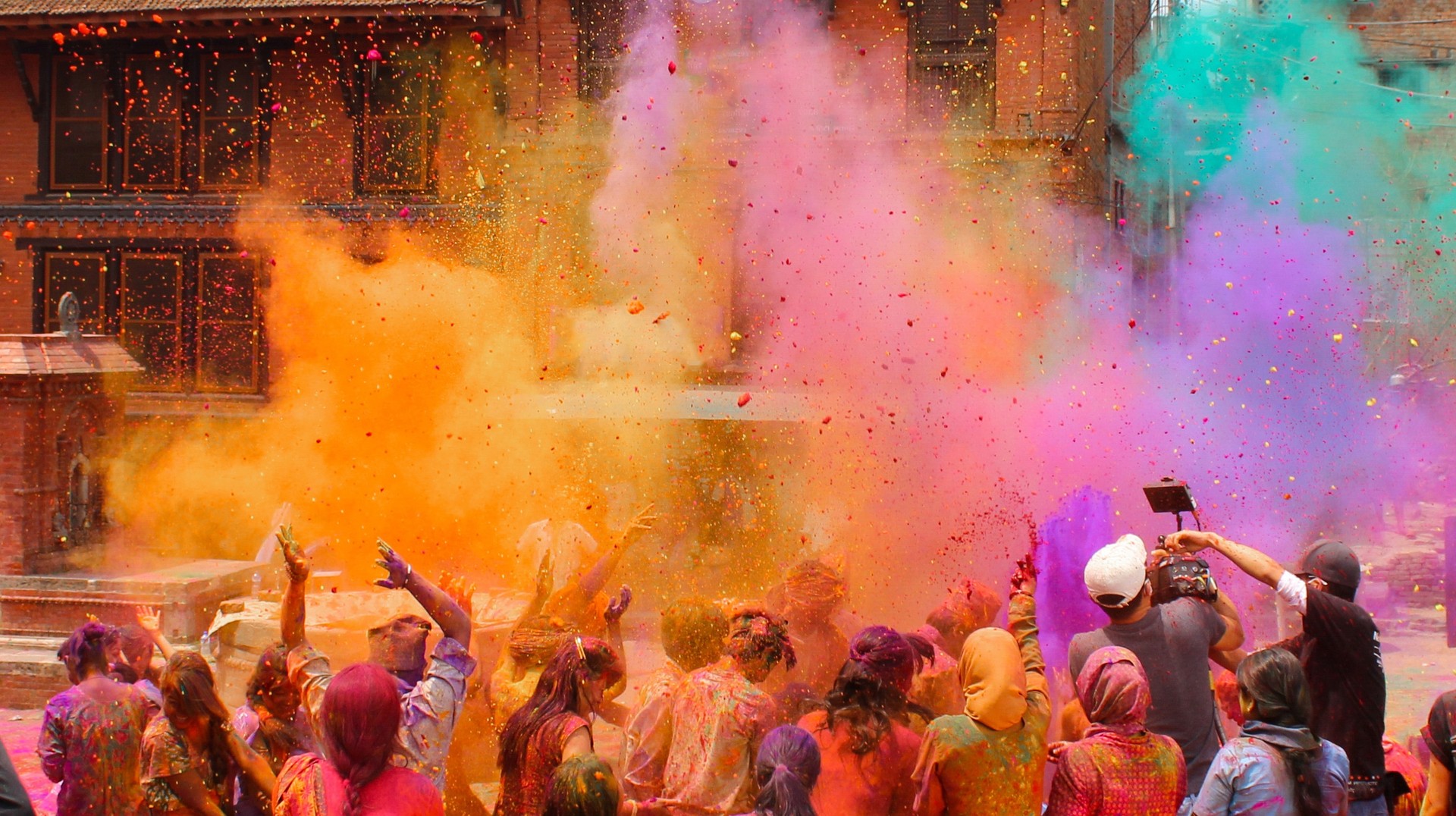 Participate in the colorful festival of Holi while touring Nepal in March. People playing Holi in Nepal in March.