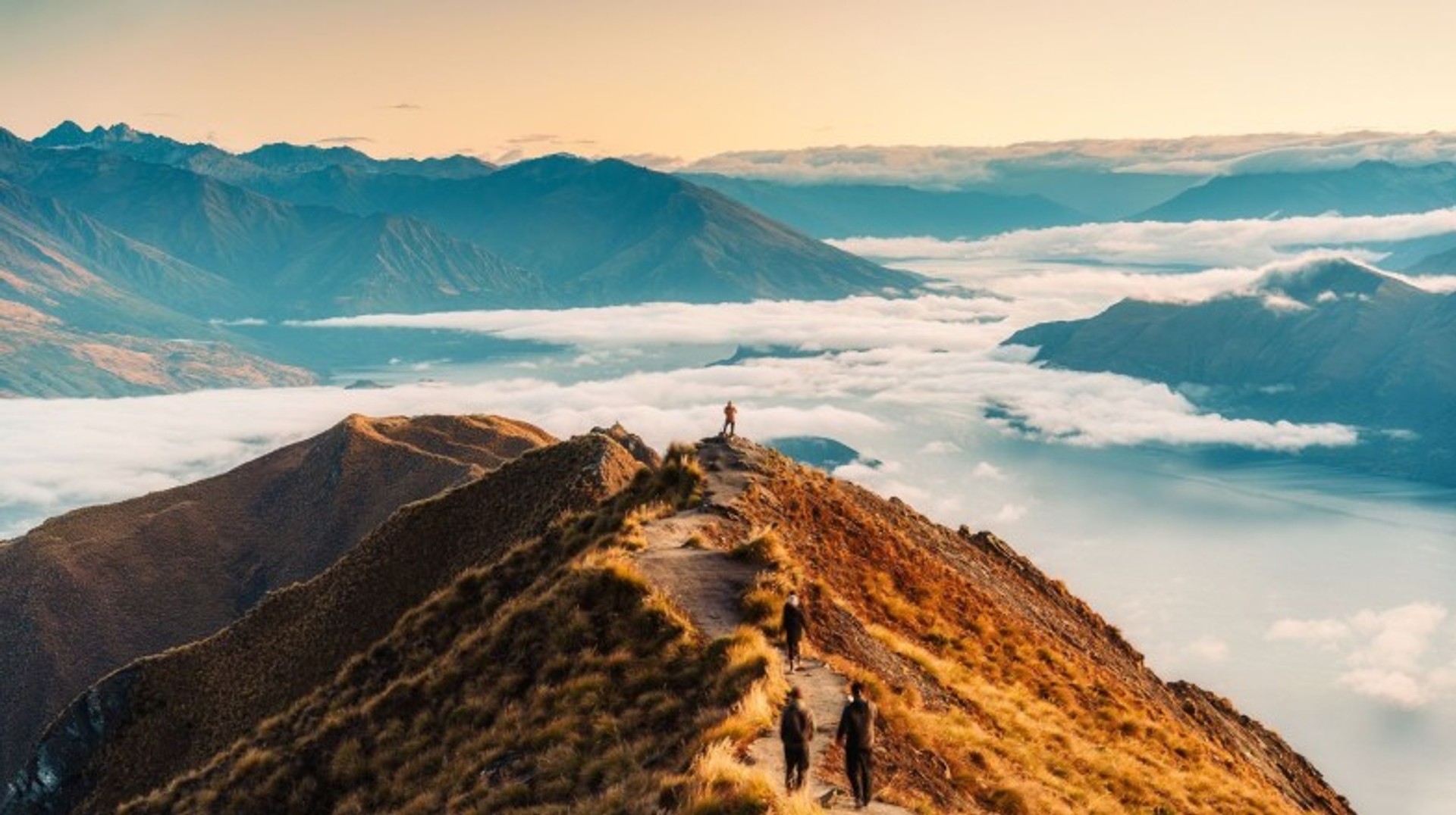 Go hiking at Roys Peak and witness the amazing landscapes during a trip to New Zealand. Hike Roys Peak with floggy clouds while spending 13 days in New Zealand.