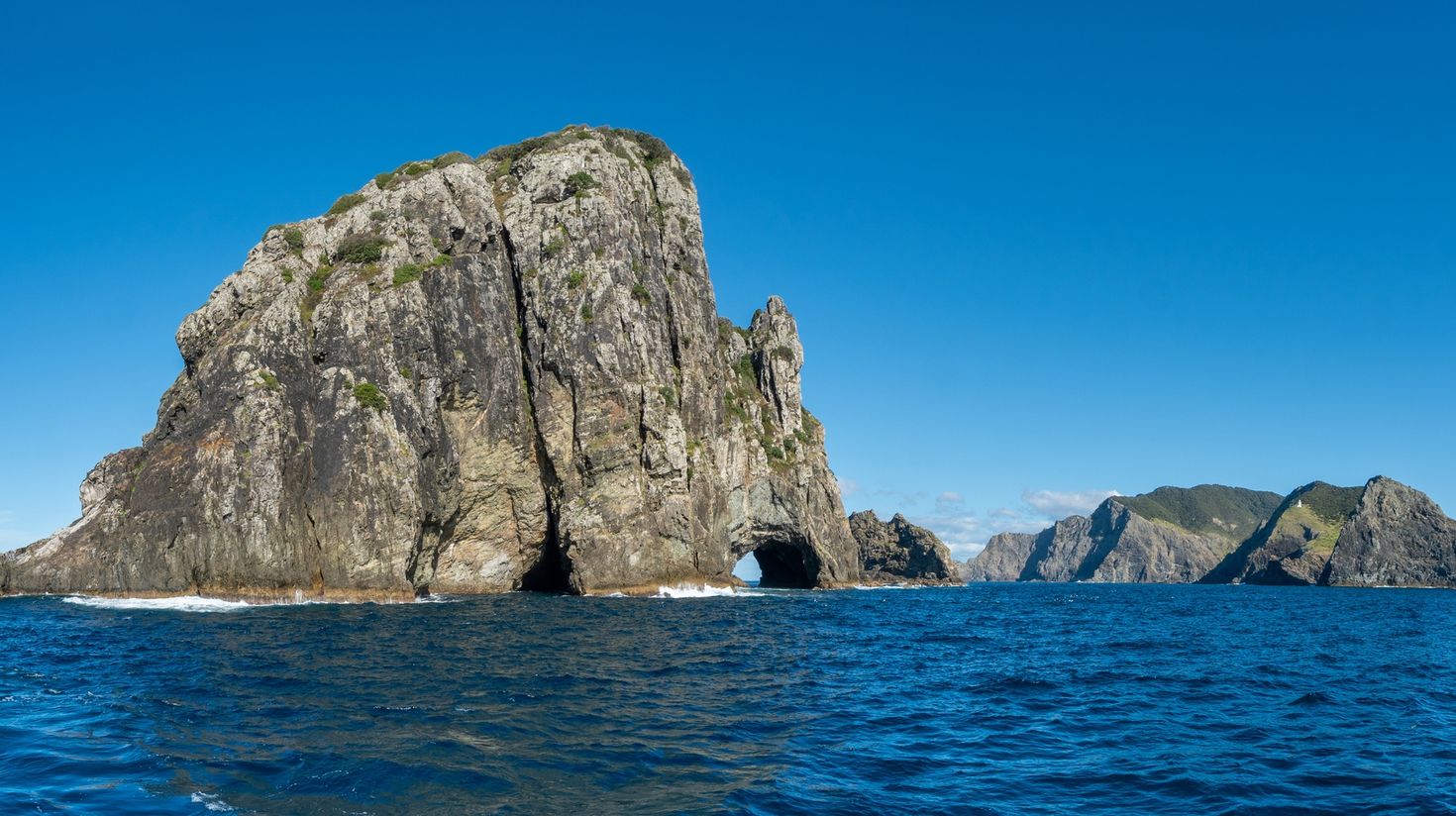 See the rock formations in Paihia in New Zealand.