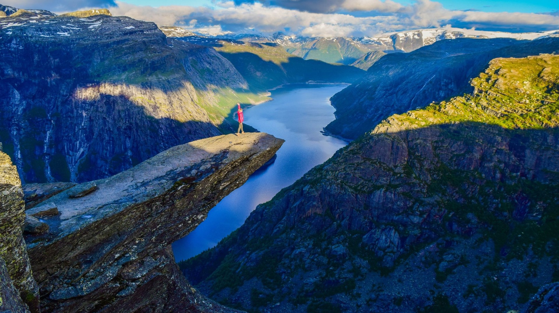 Hike Trolltunga and reach one of the country's most iconic viewpoints during your 4 days in Norway. A happy girl in top of the rock in Trolltunga during her 4 days in Norway.