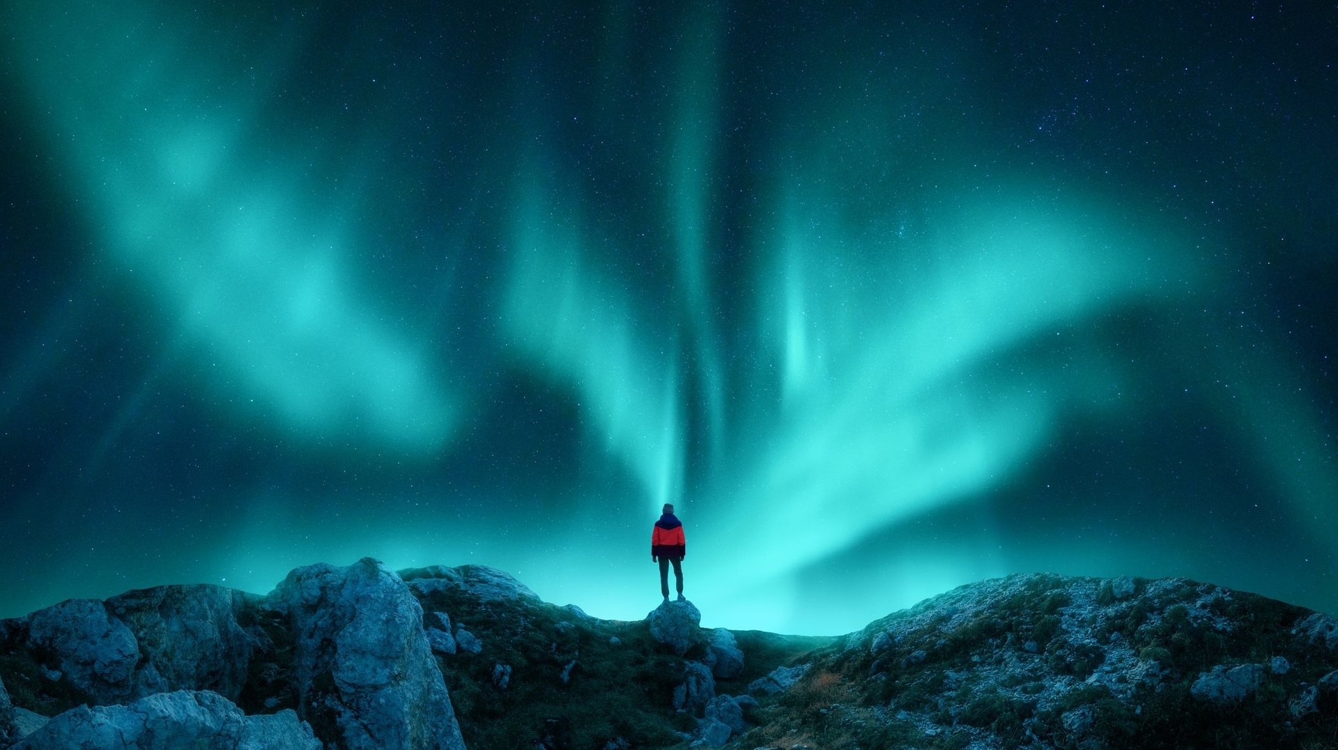 A woman admiring the beauty of the Northern Lights in Lapland during her 5 days in Norway.