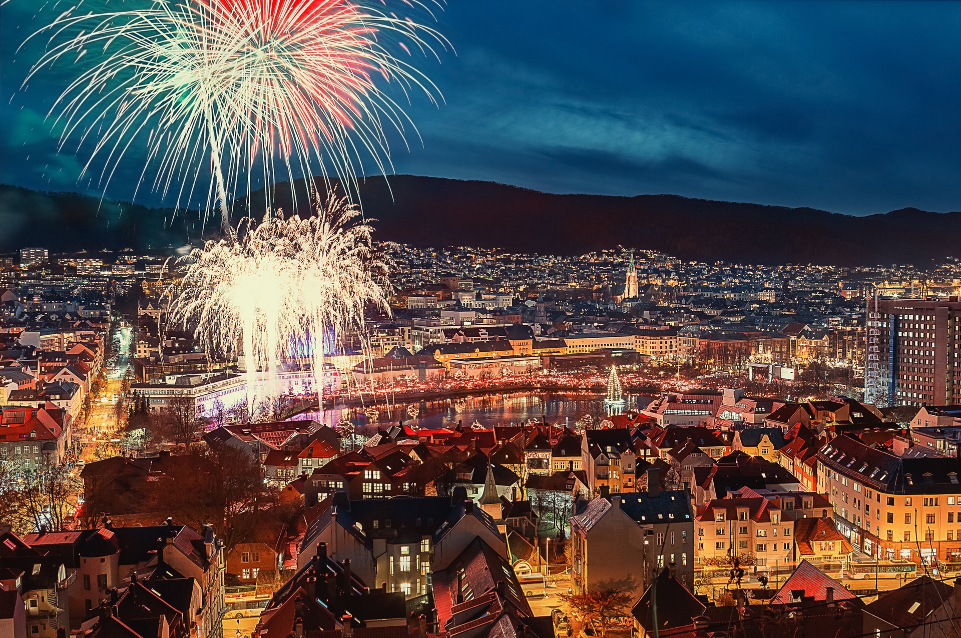 Experience the best of New Years in different cities of Norway in January. Fireworks over the city of Bergen in Norway in January.