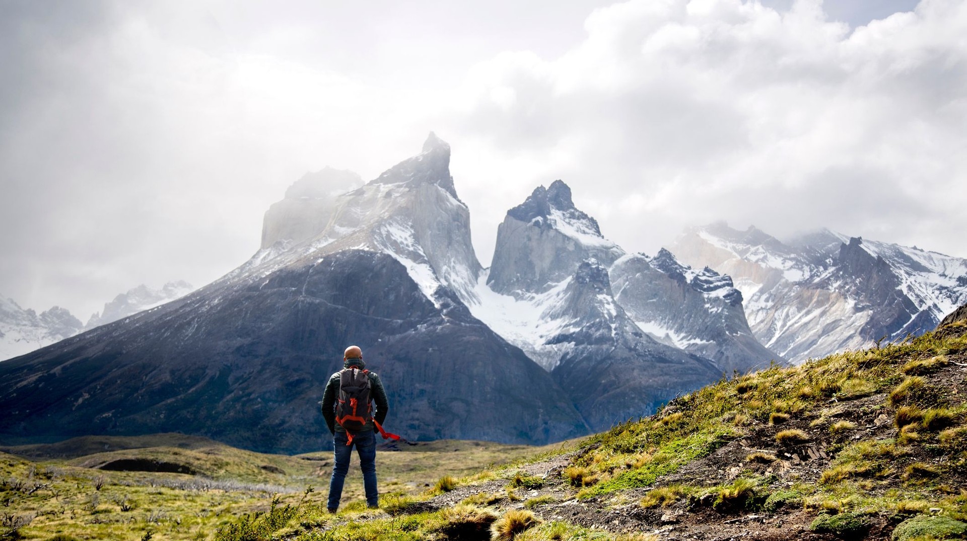 A man admiring the beauty of Torres del Paine on a cloudy day during his 4 days in Patagonia.