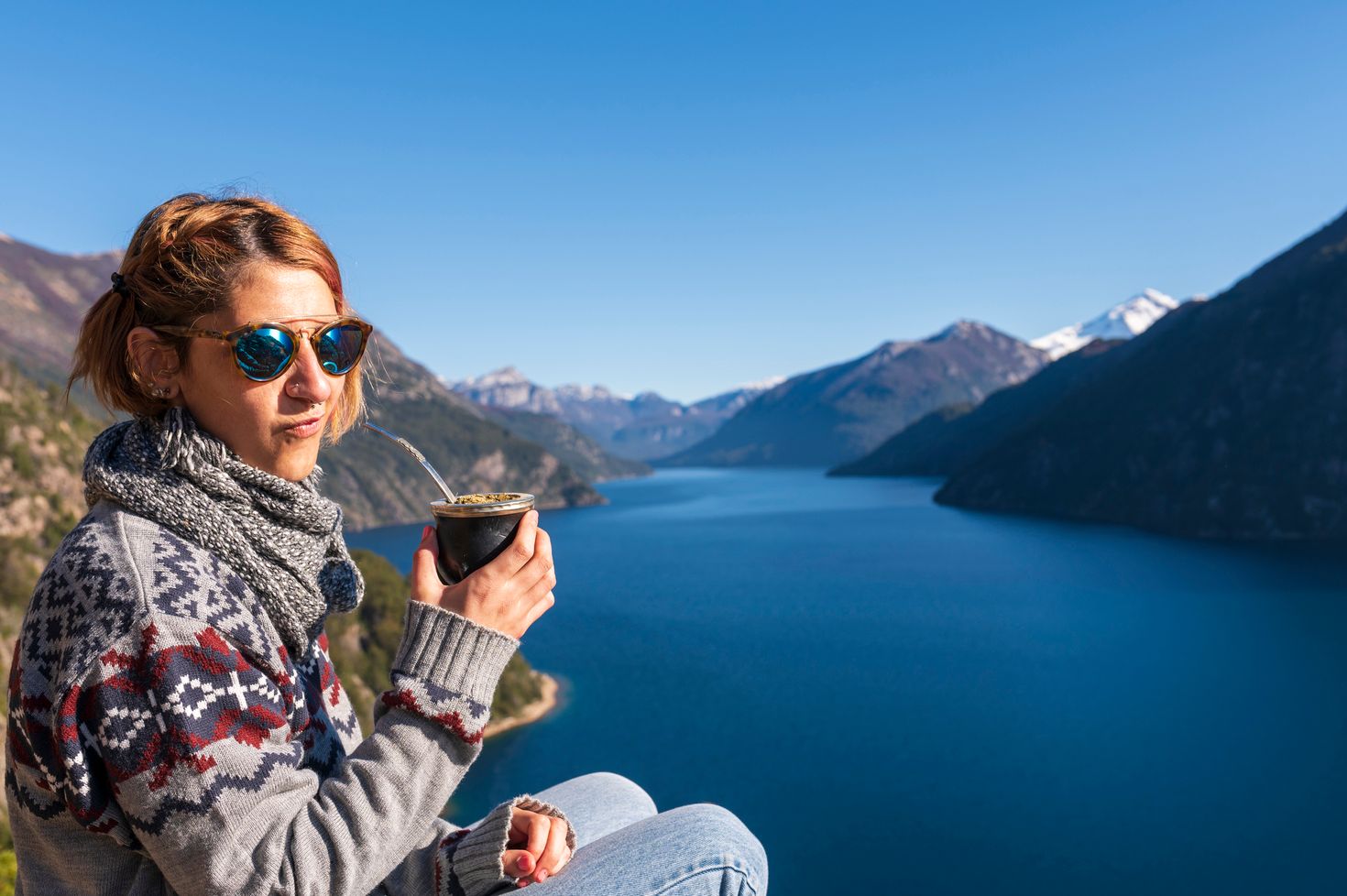 A tourist posing with her drink in Patagonia.