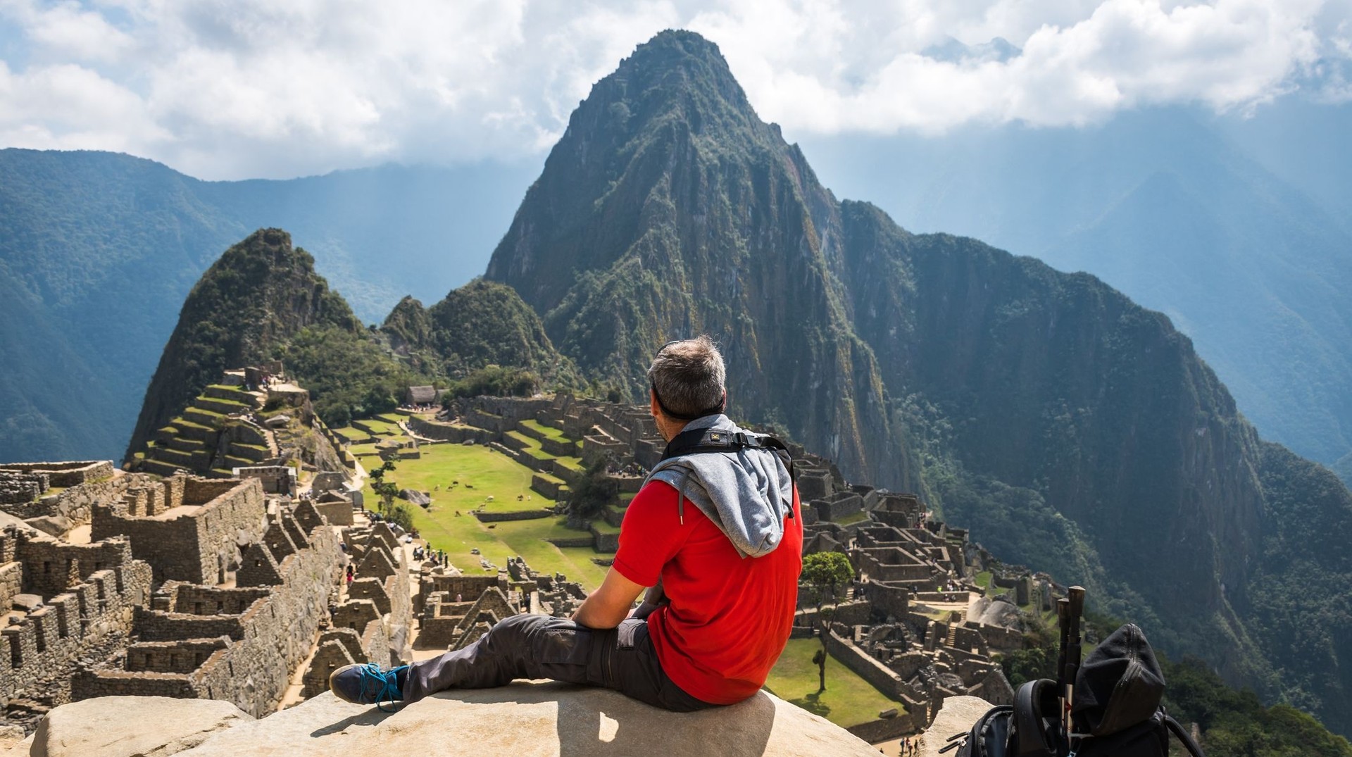 Make the most of your one week in Peru with a journey to Machu Picchu, and experience breathtaking mountain views and ancient Inca architecture. A tourist admiring the beauty of Machu Picchu on his one week in Peru adventure.