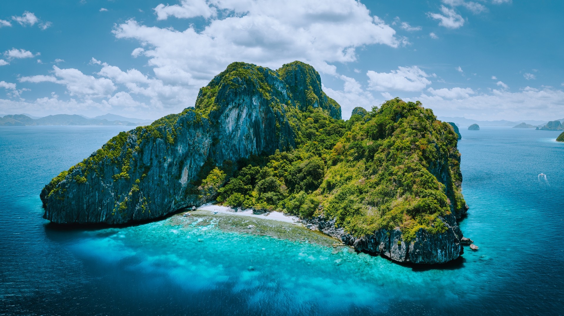 The Philippines in July is humid and rainy, but the gentle rain breeze and the calmer weather. Aerial panorama view of Entalula Island in the Philippines in July.