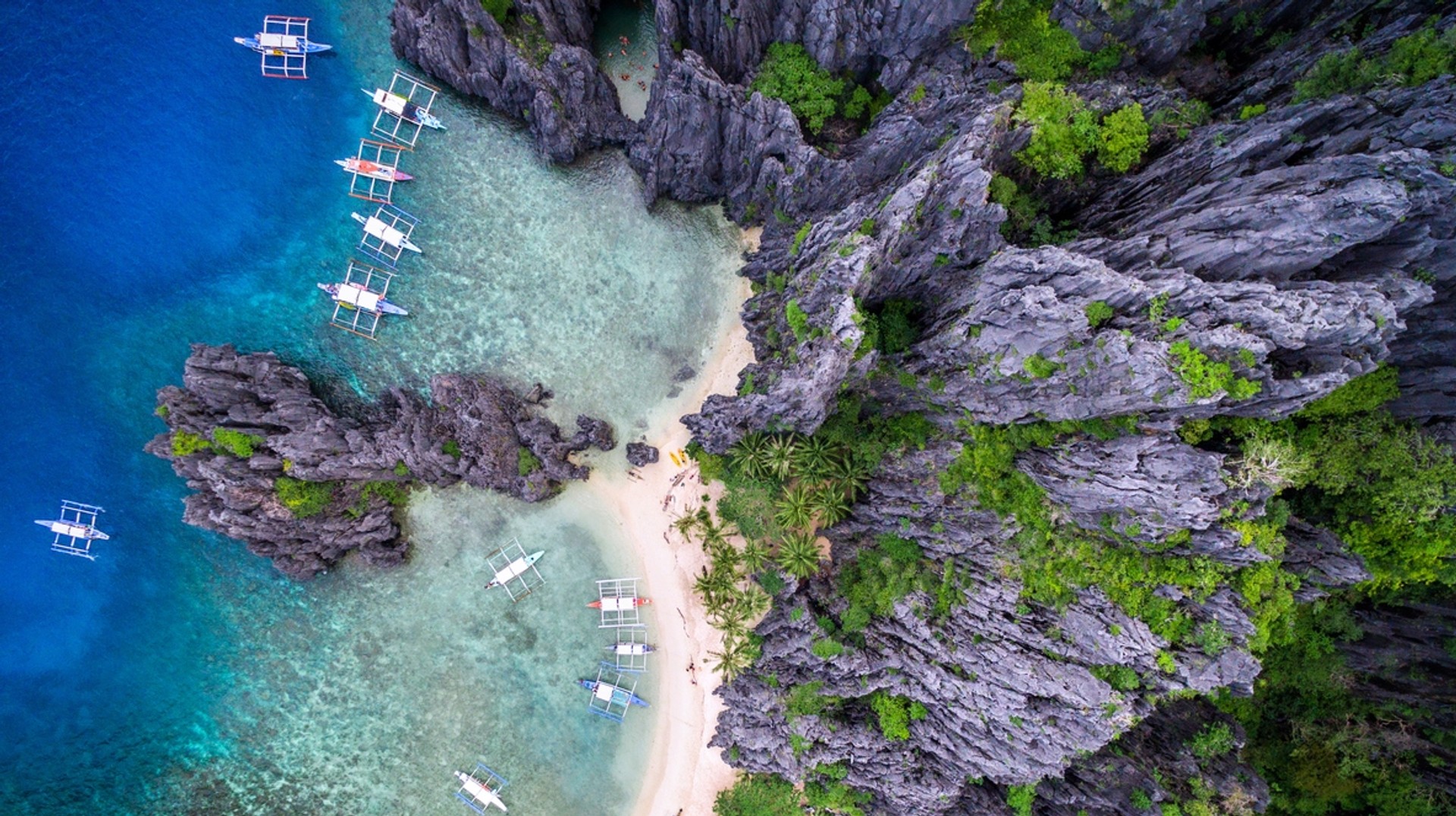 Palawan is a tropical sanctuary in the Philippines, with pristine beaches, vibrant coral reefs, and lush jungles, making it nature's masterpiece. Boats on Bacuit Bay situated on the El Nido, Palawan, Philippines in June.