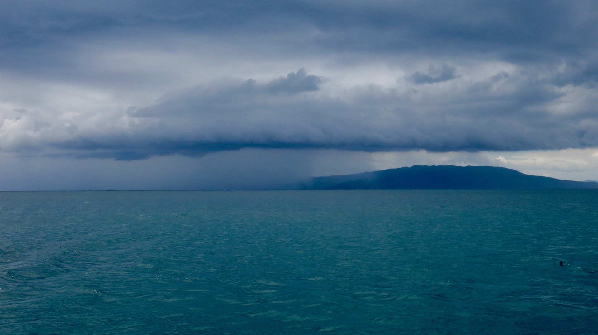 September in the Philippines lies in the middle of monsoon season. Make sure to pack clothes accordingly. Rain cloud above the ocean in the Philippines in September.