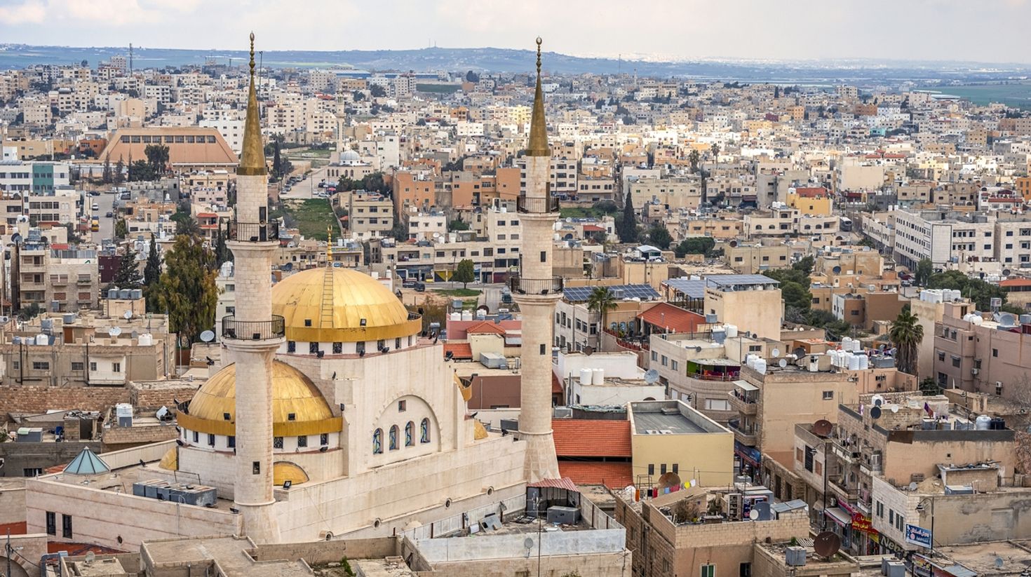 The view of the central and largest mosque with high minerates, Madaba