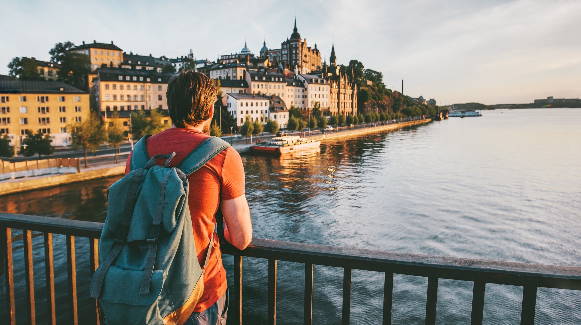 Explore Stockholm, one of the top places to visit in Sweden, where vibrant culture meets rich history and stunning waterfront views. A man admiring the view of Stockholm, one of the best places to visit in Sweden during dusk.