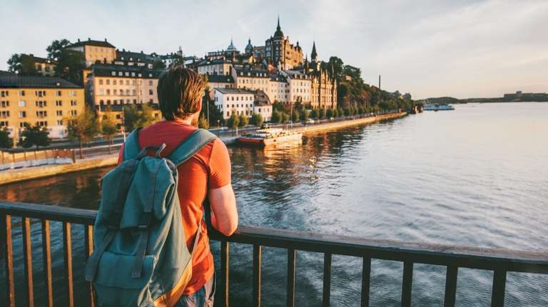 A man admiring the view of Stockholm, one of the best places to visit in Sweden during dusk.