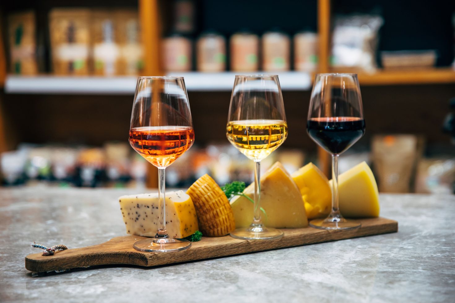 Wine bottles, glasses and cheese in restaurant, France
