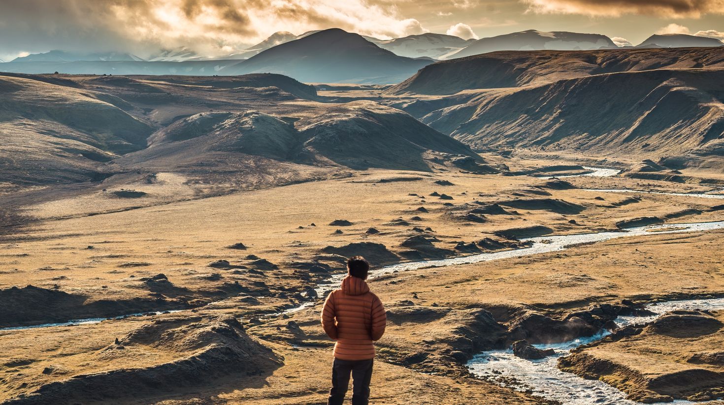 Hiker admiring the view of Icelandic Highlands during summer.