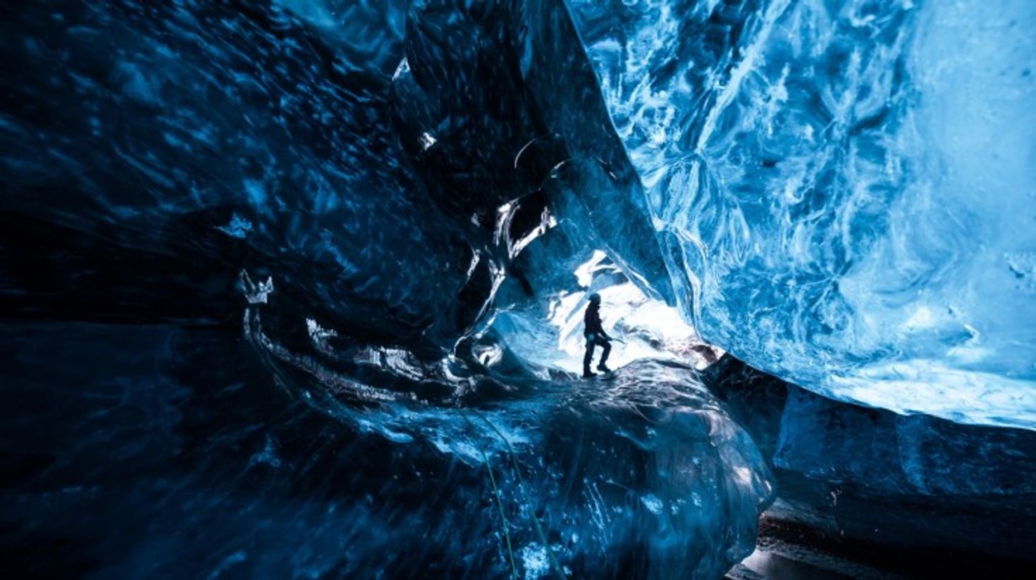 Man taking in the stunning cave views within Vatnajokull Glacier.