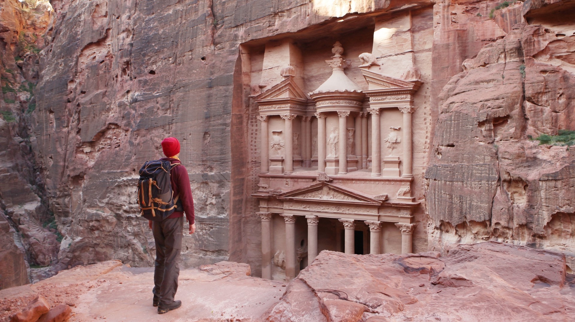Include exploring Petra while planning a trip to Jordan. A man admiring the beauty of Petra — planning a trip to Jordan.