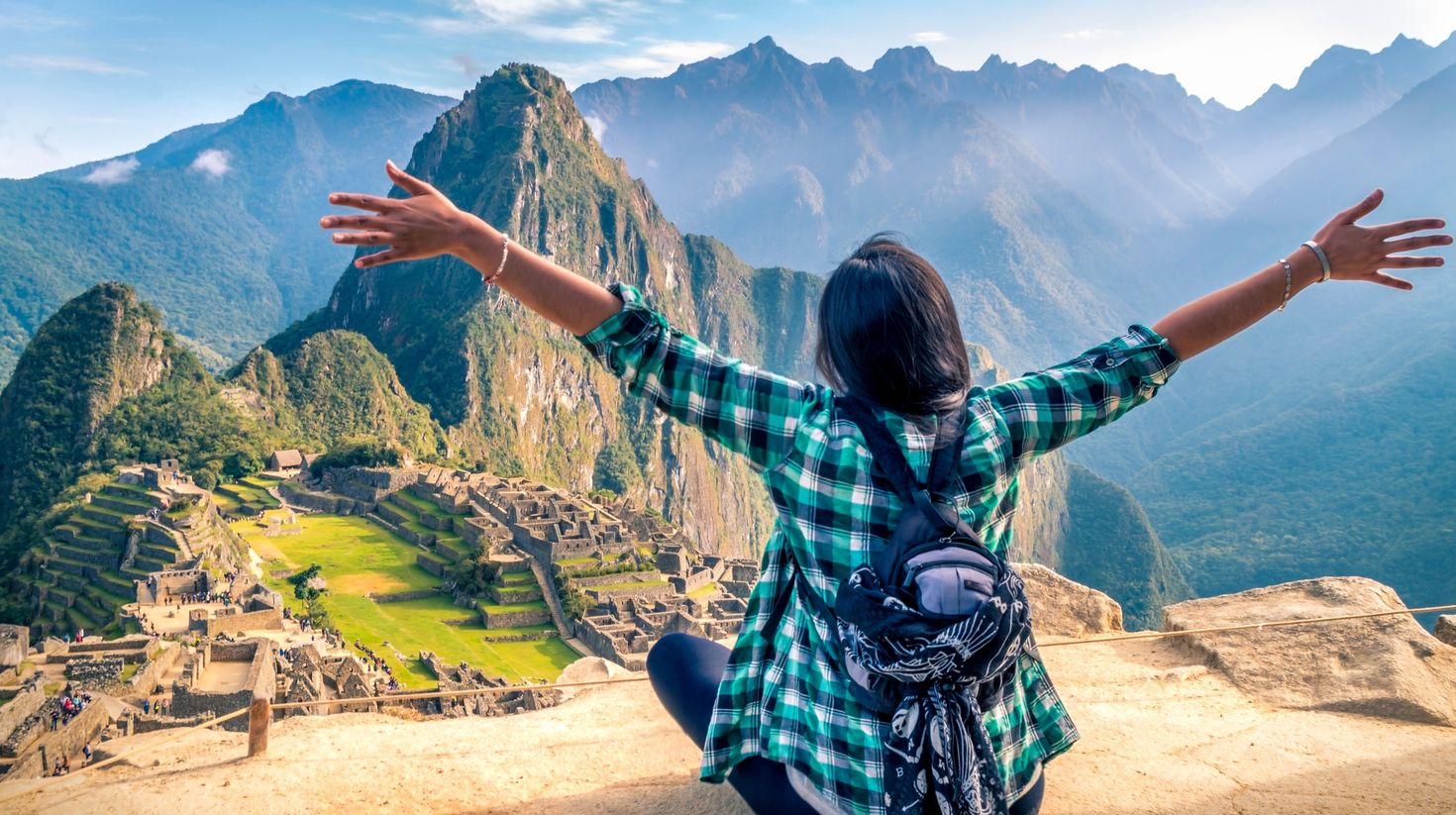 A woman enjoying the views in Machu Picchu on a solo trip to Peru.