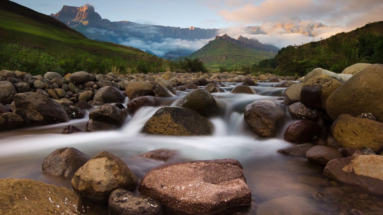 Morning light paints the peaks of the Drakensberg Mountains, with the Tugel