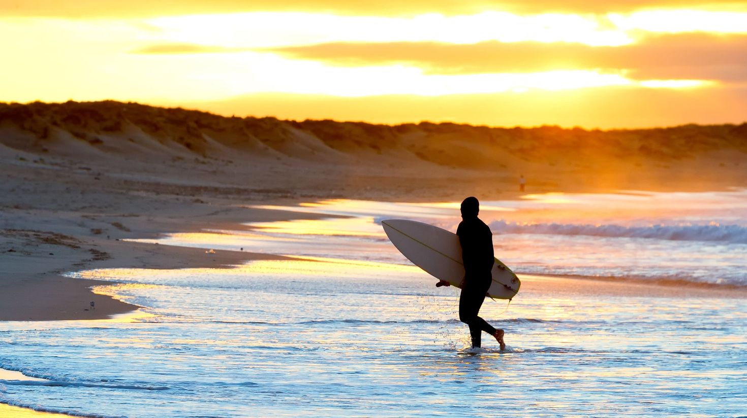 Silhouette surfer beach sunset Portugal stock photo