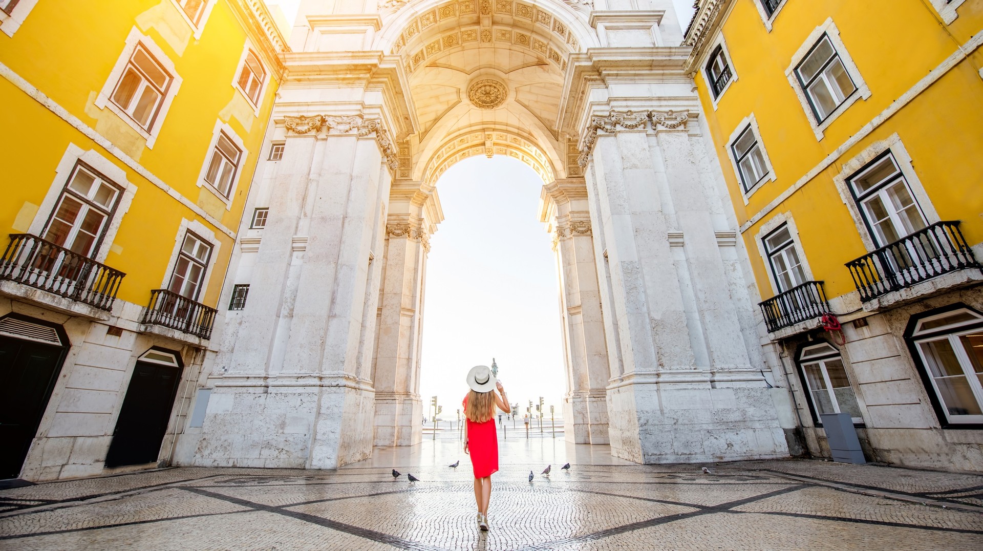 As the temperature rises in Portugal in May, the season arrives for summer activities like festivals and beach visits. Young woman tourist in Lisbon city center in Portugal