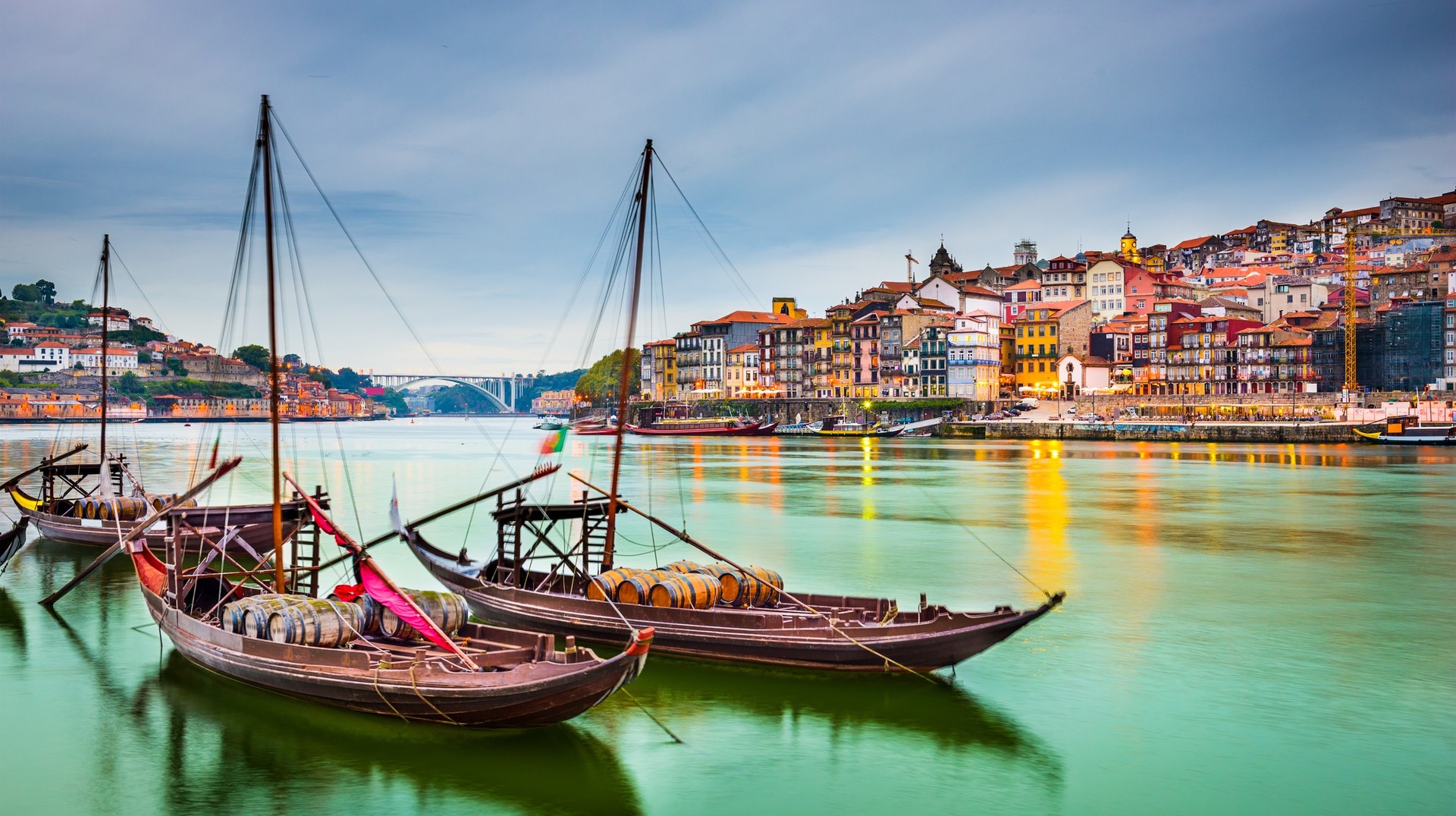The wide and calm Douro River flows through the Douro Valley to merge into the Atlantic at Porto. Taking a boat tour on the Douro River in Porto during June in Portugal