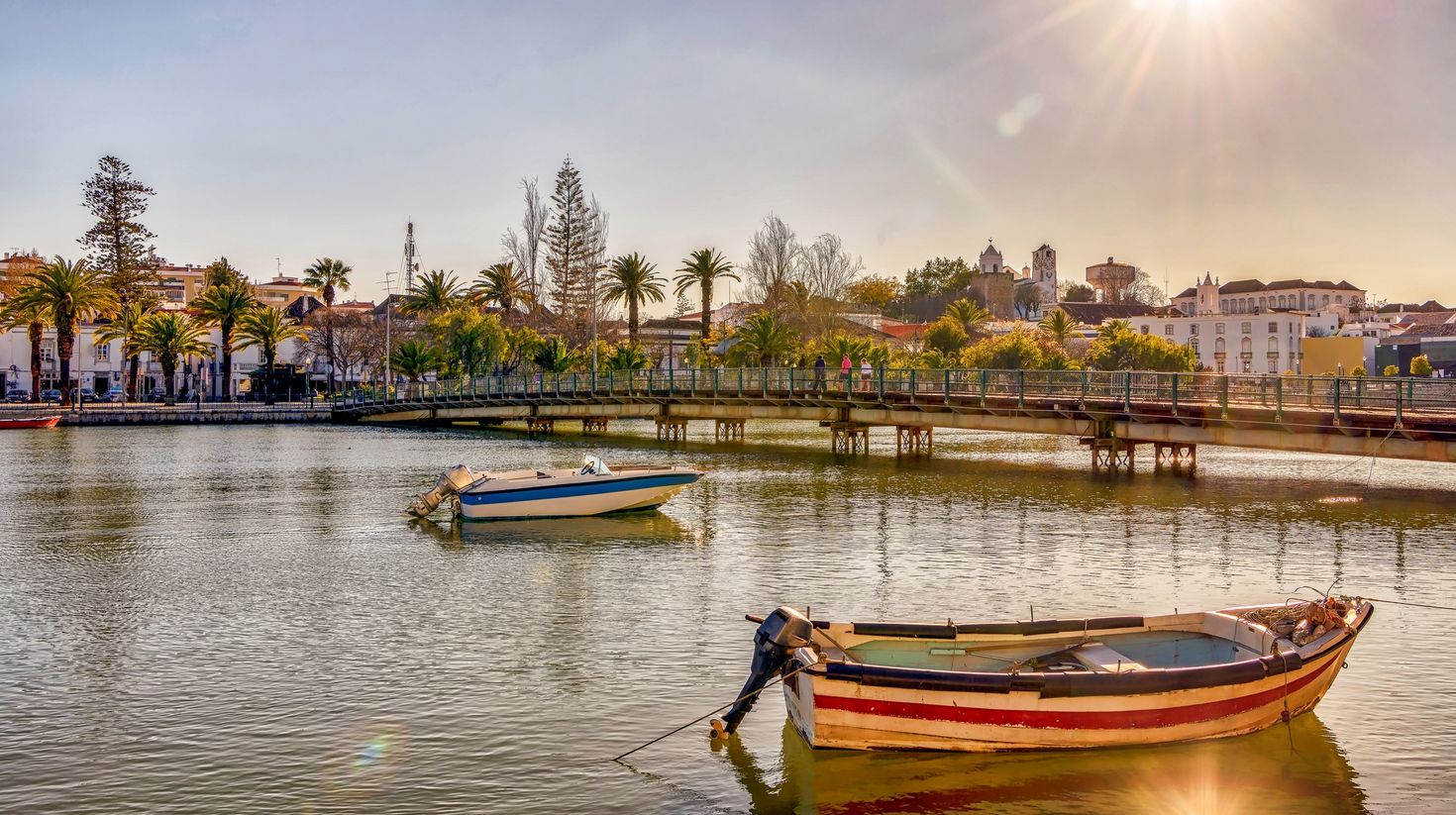 Colorful boats on Gilao river in picturesque Tavira, Portugal