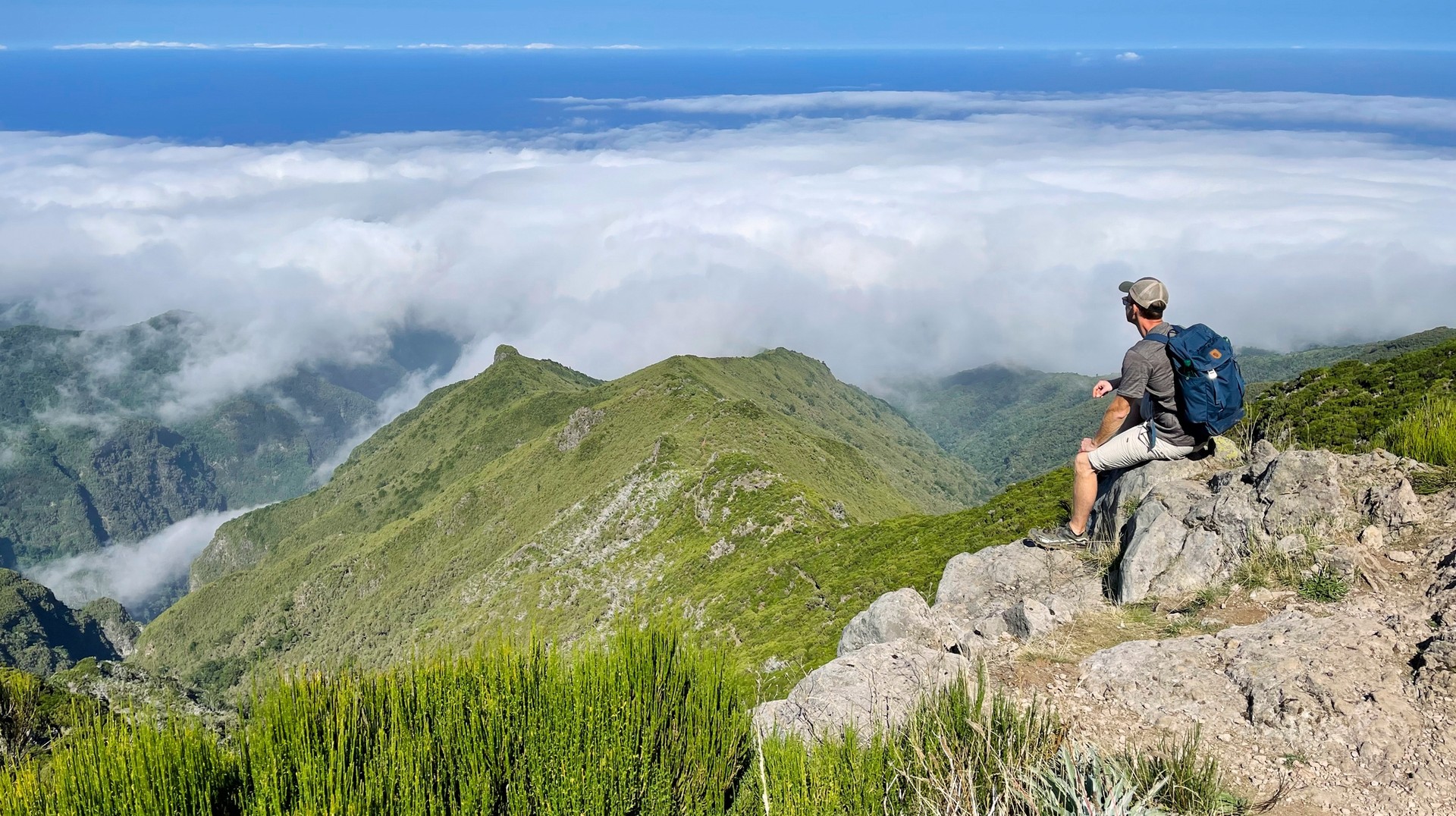 Embark on an adventurous hiking expedition in Portugal in winter. A young hiker sitting & admiring the view from above in Portugal in winter.