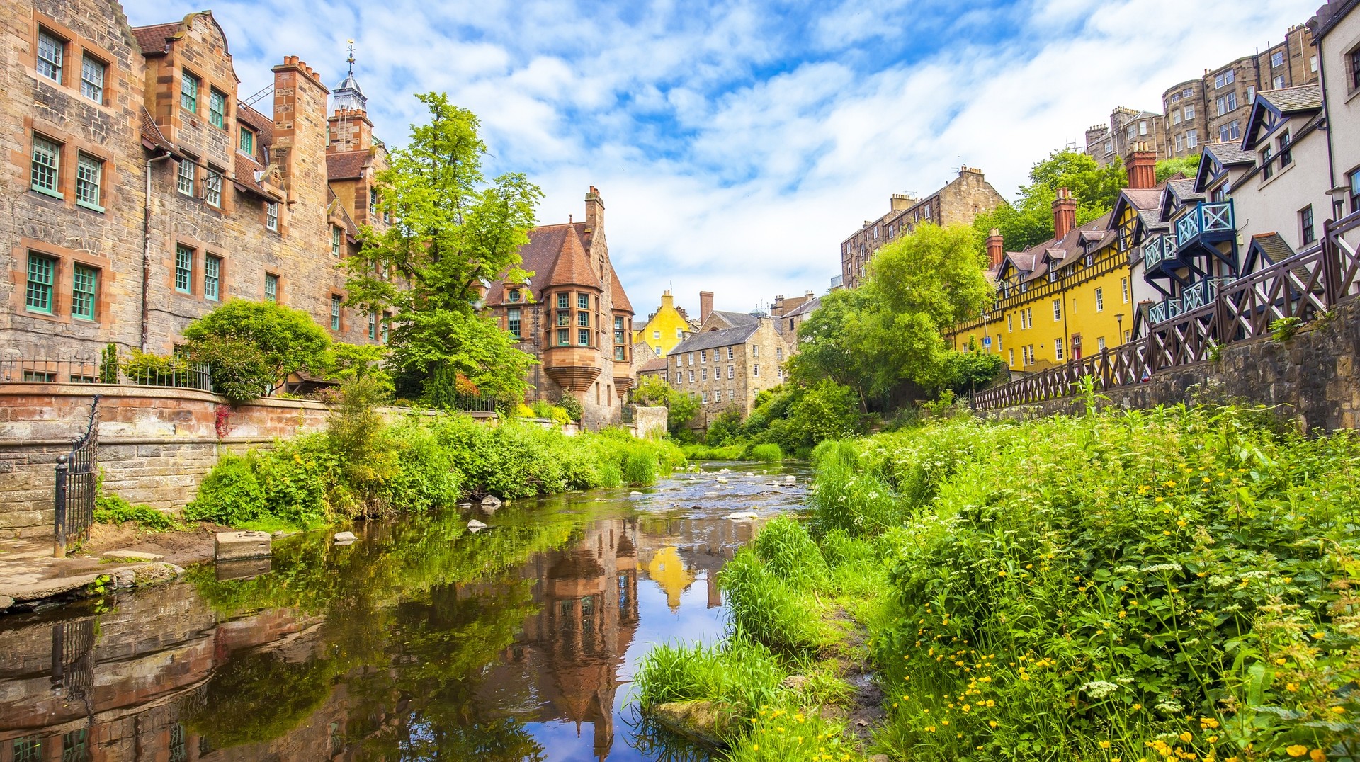 Though Scottish summers are not typically hot, the relatively warmer August is the ideal time to explore Scotland. Dean Village district in Edinburg, Scotland in August