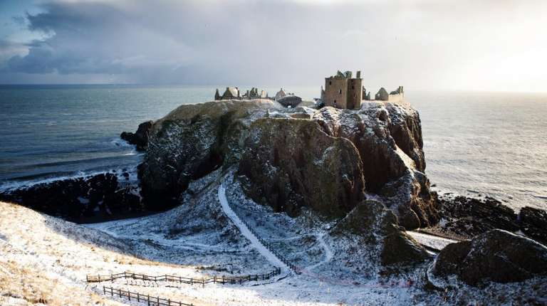 You can see the Dunnottar Castle covered in snow in Scotland in November.