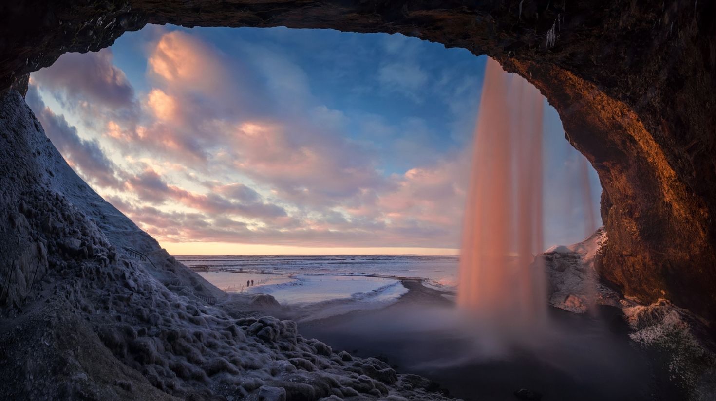 A pink sunset from behind Seljalandsfoss