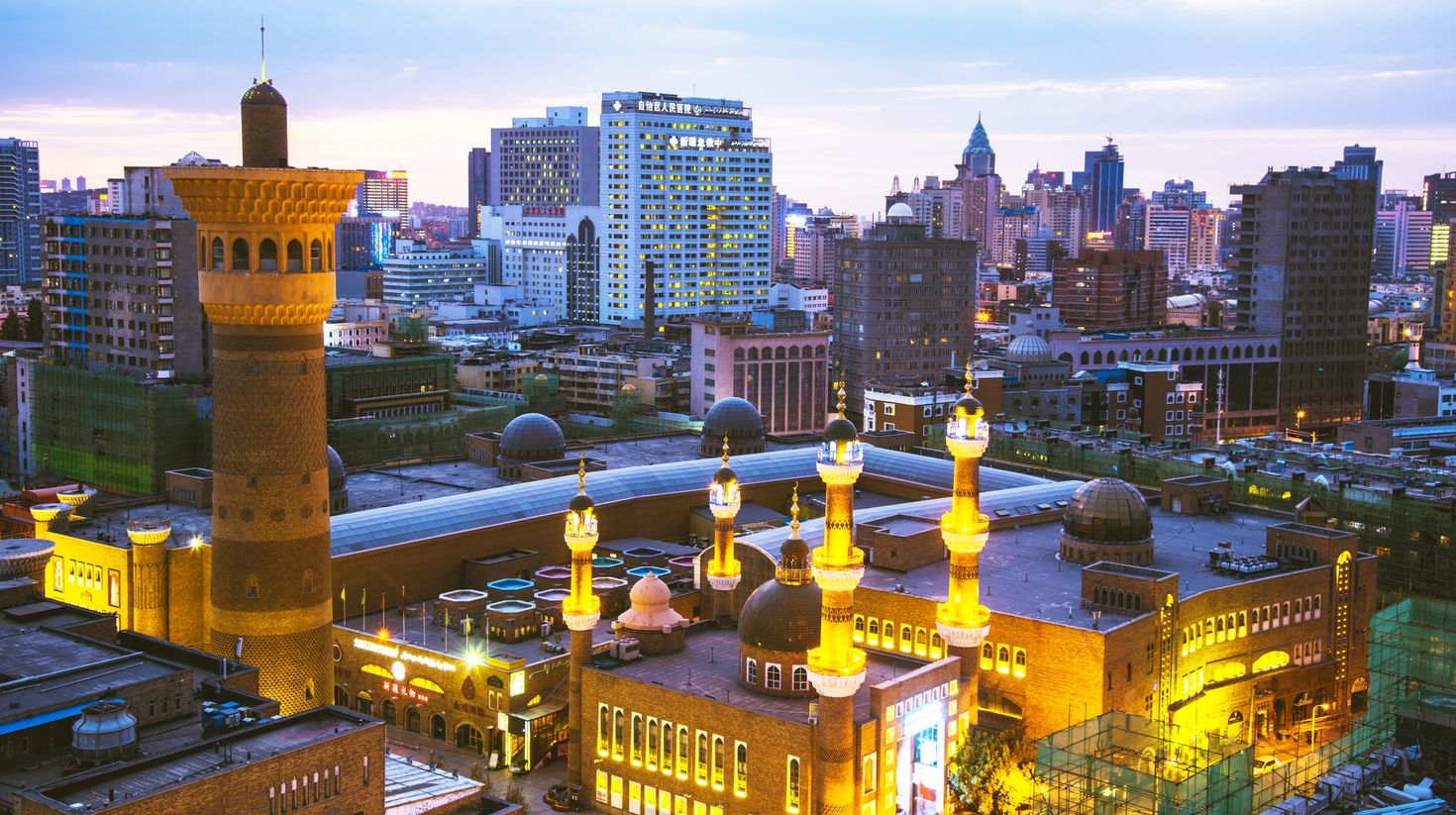 A view of well-lit tall buildings in a city
