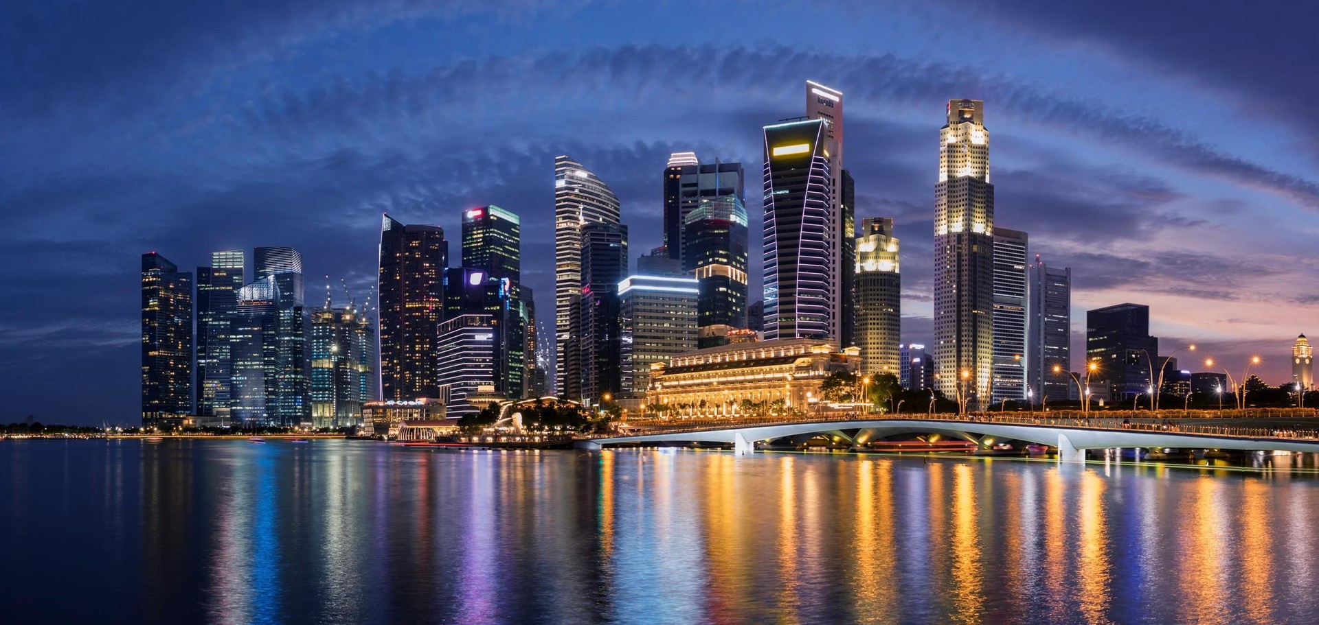 Colorful Singapore business district skyline after sun set at Marina Bay.