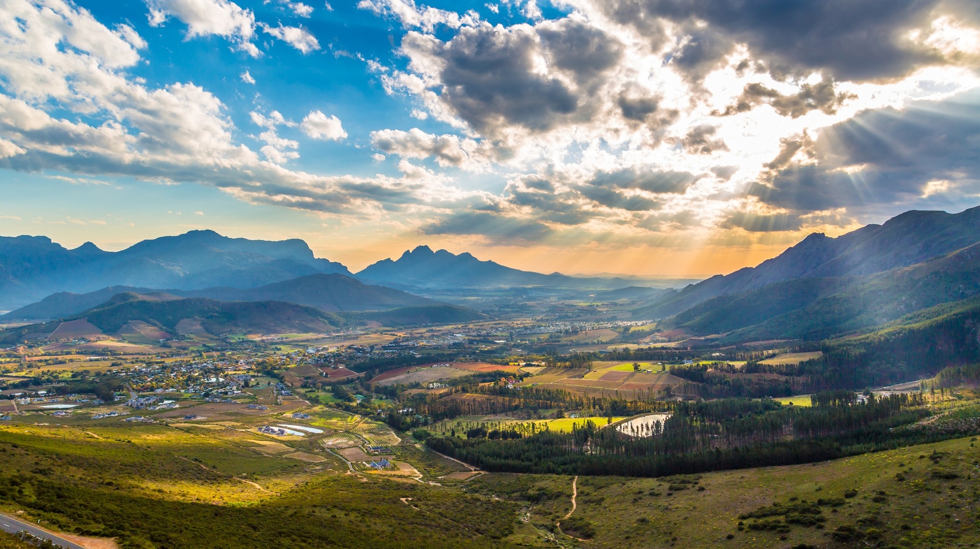 With the long warm days and spring on the horizon, a South African in August holiday in August can be lovely. Scenic view of Franschhoek in the middle of the wineyards in South Africa in August.
