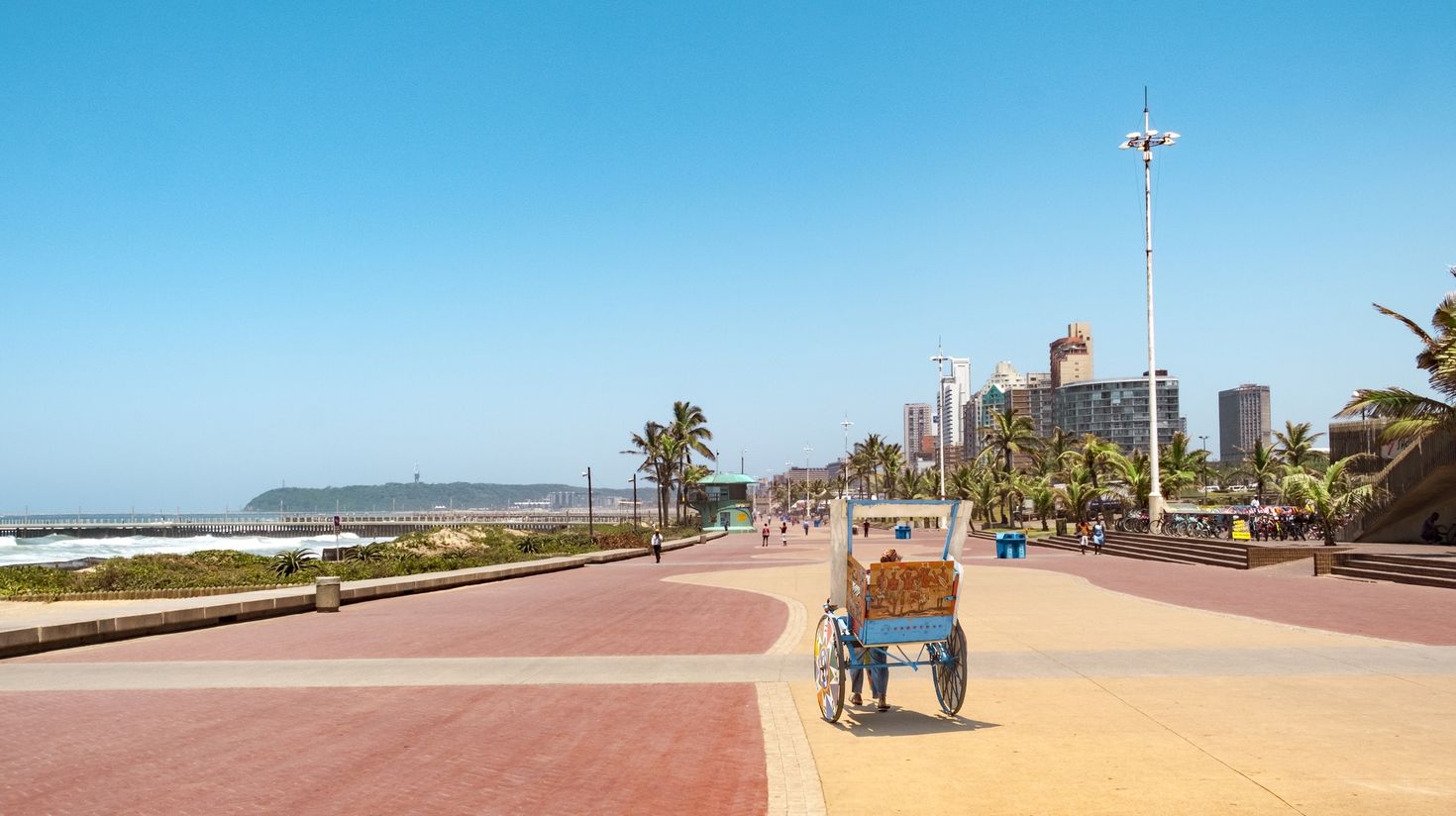 Promenade of Durban with traditional rickshaw driving on it.