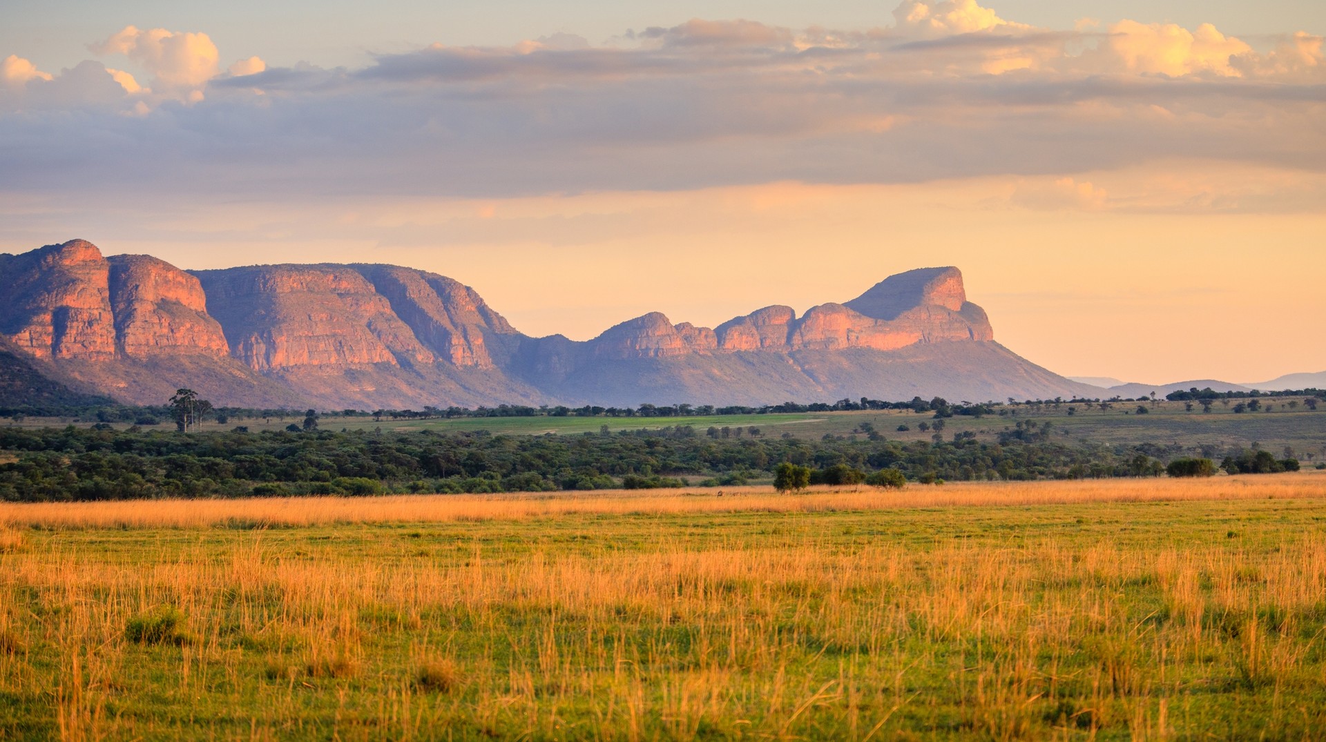 September is an ideal month for a South African safari holiday as it is the birthing season for a lot of the wildlife. Sunrise over the water berg mountains in South Africa in September.