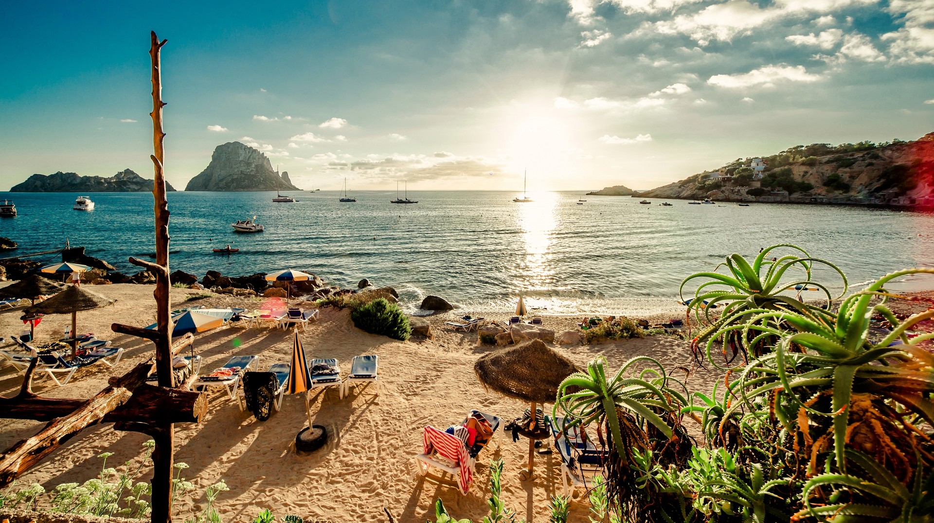 The summer sun hardly gets any break in Spain, allowing ample opportunities for beach activities. View of Cala d'Hort Beach, Ibiza, Spain in August