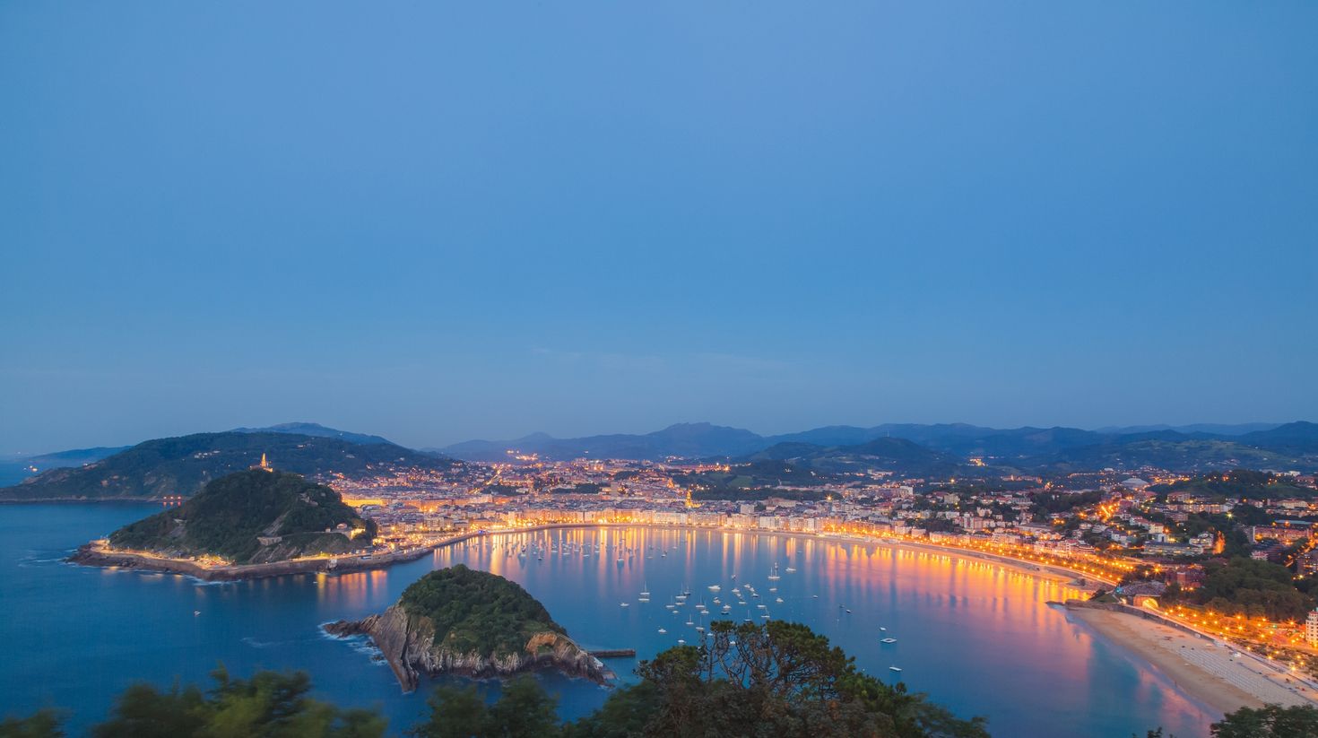 Classic evening view of Ondaretta and La Concha beaches of San Sebastian